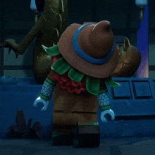 a lego character wearing a wizard hat stands in front of a dragon