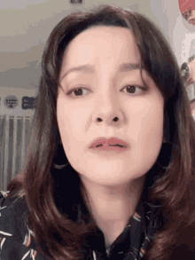 a close up of a woman 's face with her mouth open
