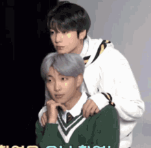 a man in a green sweater is standing next to another man