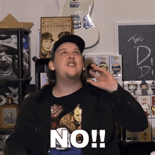 a man in a black jacket says no in front of a guitar