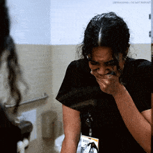 a woman with a name tag that says nurse on it is crying