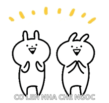 a couple of rabbits are standing next to each other and smiling .