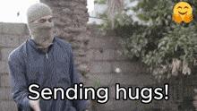 a man in a mask is sending hugs to someone