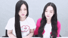 two girls are sitting next to each other with one wearing a shirt that says " buenos aires "