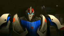 a close up of a transformer with the letters tf on his chest