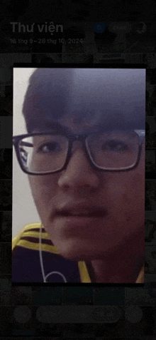 a picture of a man with glasses is displayed on a screen