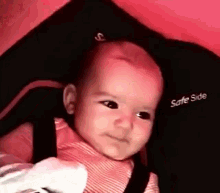 a baby is sitting in a car seat with the word safe side on it
