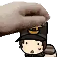 a person is petting a cartoon character with a hat on his head .