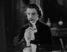 a black and white photo of a man with a pipe