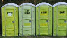 a row of johnny portable toilets are lined up