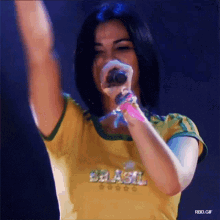 a woman wearing a yellow shirt that says brasil on it