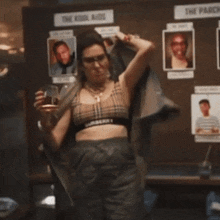 a woman is pointing at a sign that says the kool aids