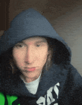 a woman wearing a blue hoodie with the word sky on it