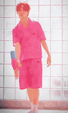 a man in a pink shirt and pink shorts is standing in front of a glass wall