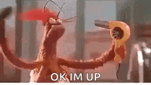 a cartoon octopus is holding a hair dryer in its mouth .
