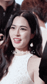 a woman in a white dress with a sticker that says 00-c-ck-g on it