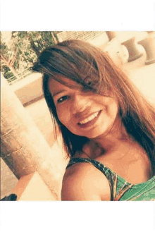 a woman is smiling for the camera while taking a selfie .