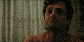 a close up of a man 's face with his shirt off