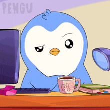 a blue penguin sits at a desk with a cup of coffee