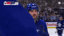 a hockey player wearing a blue helmet with ccm on it