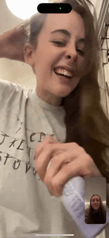 a woman wearing a t-shirt with the alphabet on it is smiling