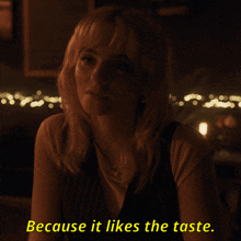 a woman says because it likes the taste while sitting at a table