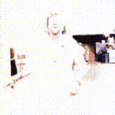 a man with a beard is standing in a kitchen wearing a white hat