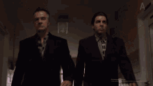two men in suits are standing next to each other in a hallway and the screen says " activate windows "