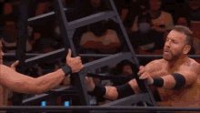 a wrestler is being pinned by another wrestler in a wrestling ring