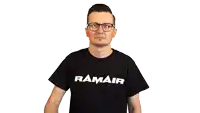 a man wearing glasses and a ramair t-shirt