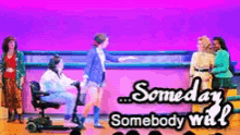 a group of people on a stage with the words someday somebody will written on it