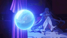 a girl is sitting on a bed with a blue ball in the background