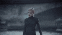 a blurred image of a woman in a black bodysuit