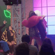 a woman in a yellow jacket is holding another woman in a red jacket