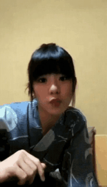 a woman wearing a blue shirt with a floral pattern on it