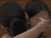 a woman is covering her face with a napkin while another woman looks on