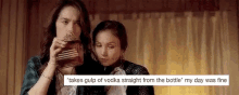 a couple of women standing next to each other in a room .