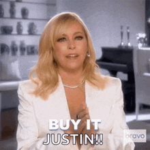 a woman in a white jacket says " buy it justin "