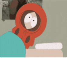 a cartoon of kenny from south park is sitting on a table