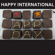 a tray of chocolate squares with the words happy international written on them