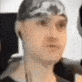 a close up of a man wearing headphones and a headband .