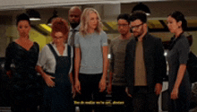 a group of people standing next to each other .