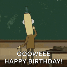 a cartoon character with a banana head is standing in front of a blackboard and says `` happy birthday '' .