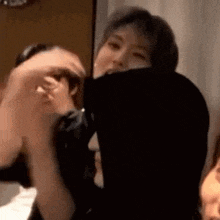 a group of people are standing next to each other in a room holding hands .