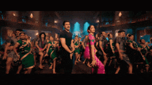 a man and woman are dancing in a crowd of people