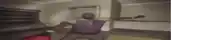 a blurry picture of a man in a purple shirt holding a red boxing glove .