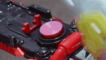 a close up of a toy with a red button that says l