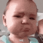 a baby is crying and saying `` me '' while being held by a person .