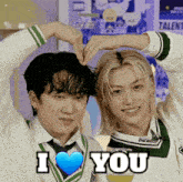two young men are making a heart shape with their hands and the words " i love you "
