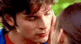 a close up of a woman touching a man 's forehead